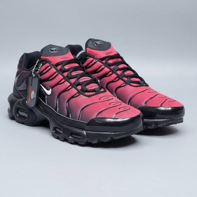 Pink and black sneakers with a brand tag on a blurred background
