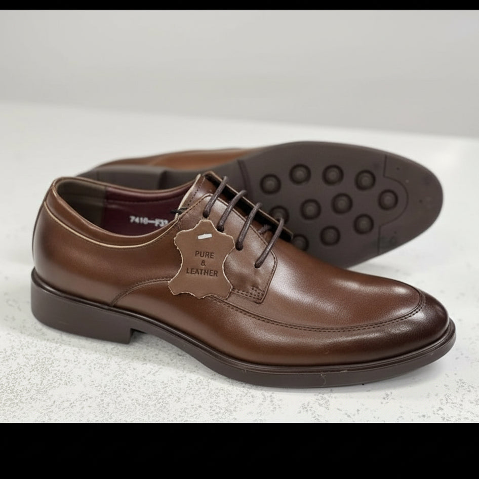 Brown leather shoes with a visible 'Pure Leather' label on a light background