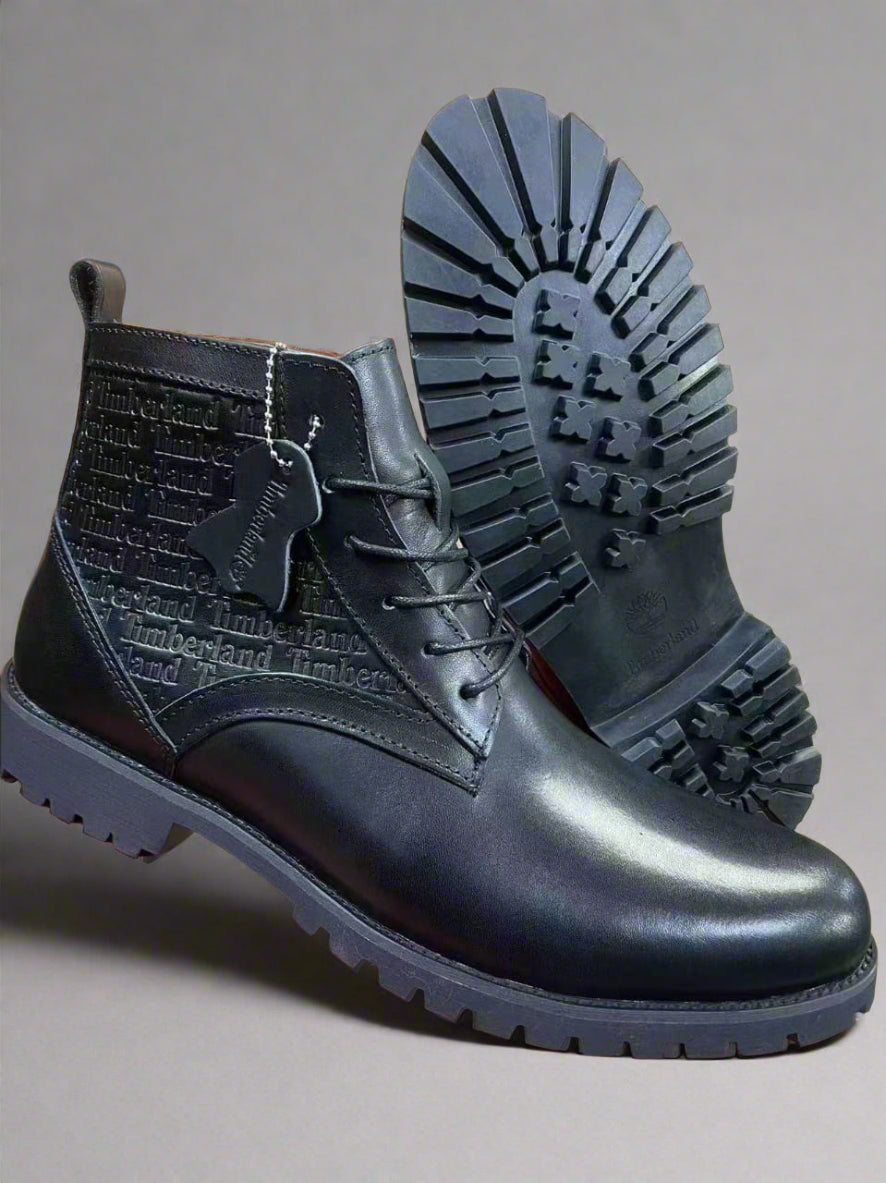 Black leather boots with a prominent sole on a red and black platform.