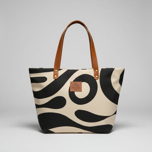 Person reading a book next to a panda-patterned bag on a wooden surface.