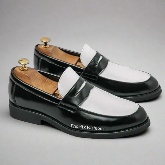 Black and white loafers with wooden soles on a grid background, branded 'Phoelix Fashions'.