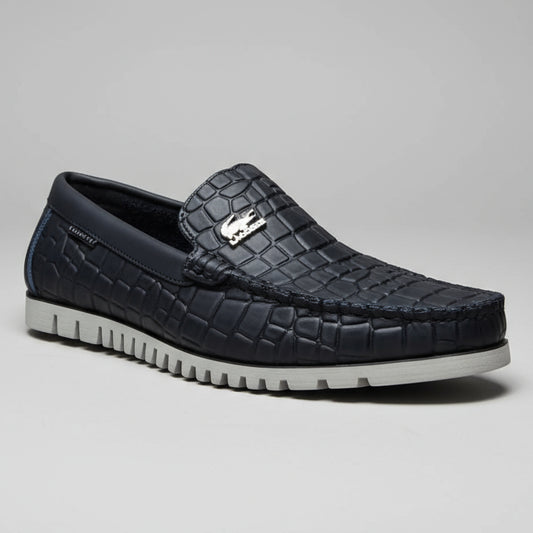 Person holding a black textured shoe with a brand logo against a blurred background