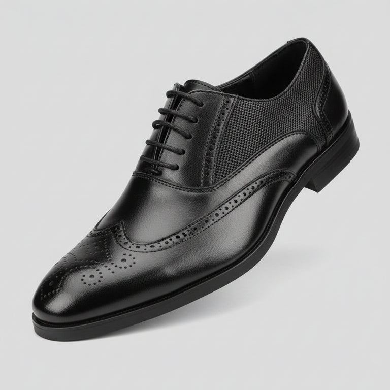 Black dress shoe held in front of a shoe rack with various shoes.