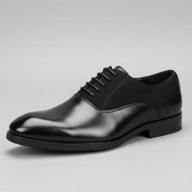 Black leather shoe held in front of a shoe rack with various shoes displayed.