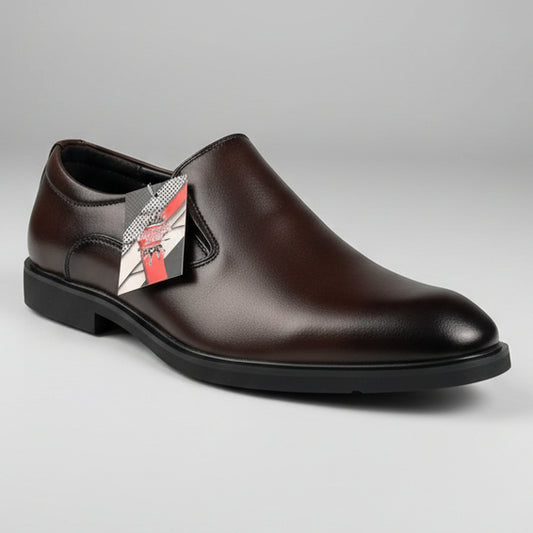 Brown leather shoe held by a person with a store interior in the background