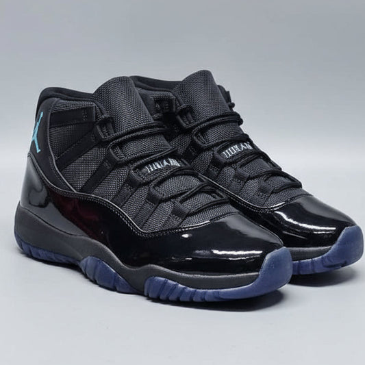 Black high-top sneakers with blue soles held over a box, with a 'welcome' sign in the background.