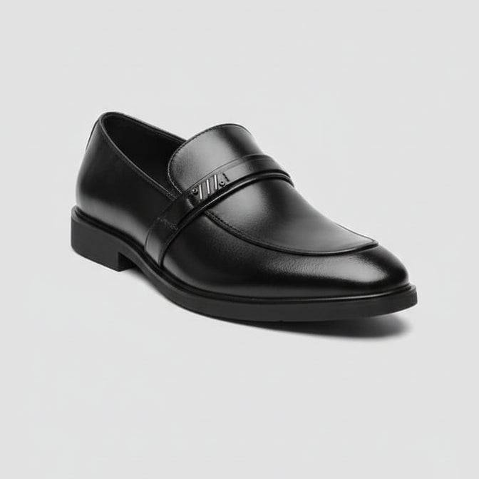 Black leather loafer shoe on a light gray background