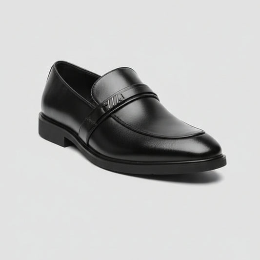 Black leather loafer shoe on a light gray background