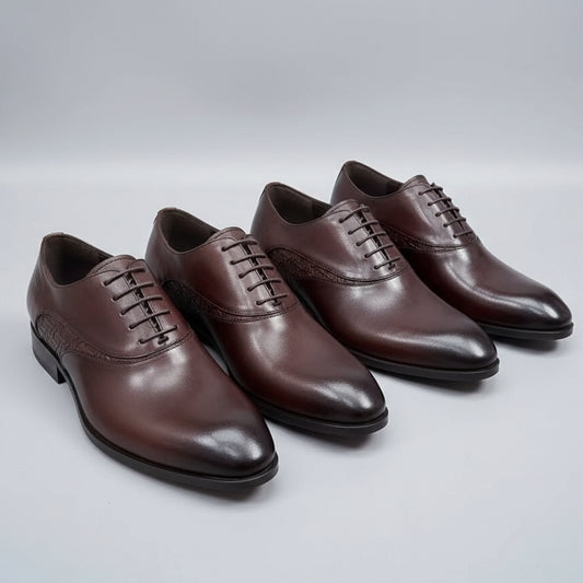 Set of brown dress shoes on a textured surface