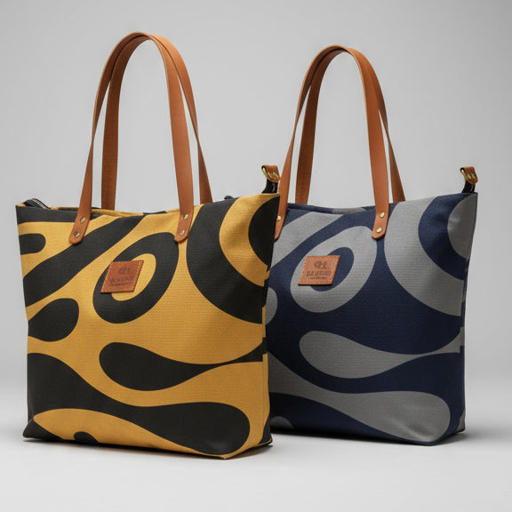 Three bags with abstract patterns on a wooden surface.