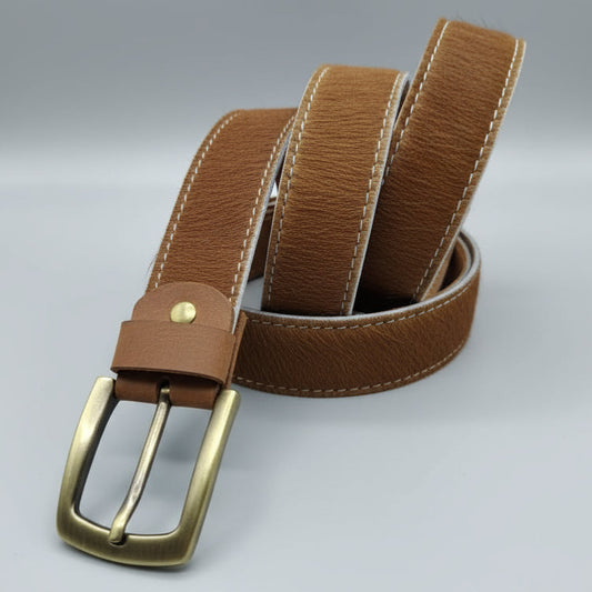 Brown leather belt with brass buckle on a wooden surface