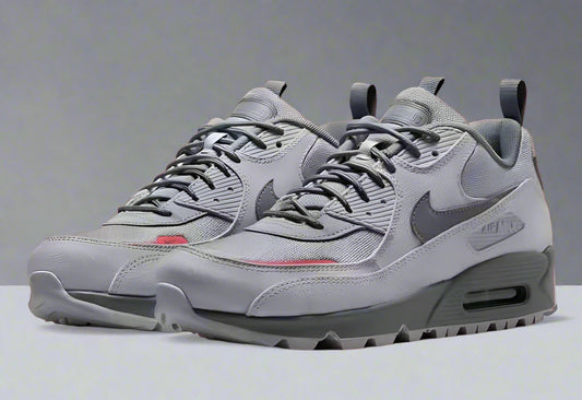Gray sneakers with a Nike logo on a red background