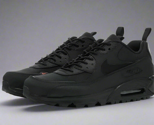 Black Nike sneakers on a white background