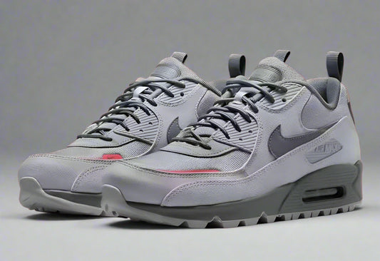 Gray sneakers with a Nike logo on a red background