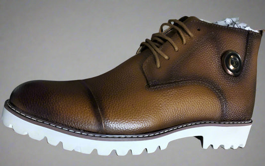 Brown leather shoe held by a hand on a blurred background