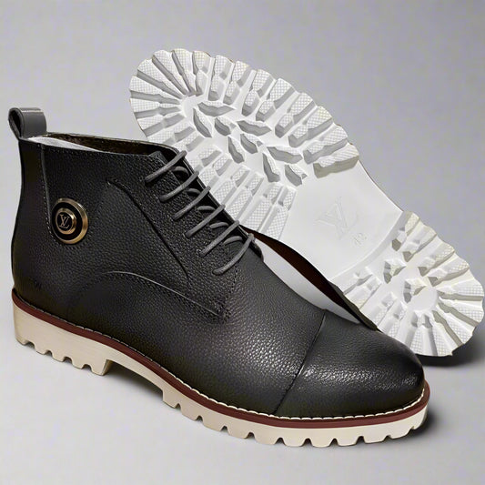 Black leather boot with white sole on a cardboard surface, workshop in the background