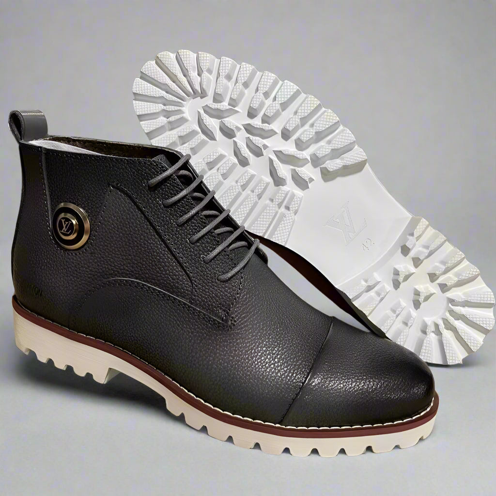 Black leather boot with white sole on a cardboard surface, workshop background