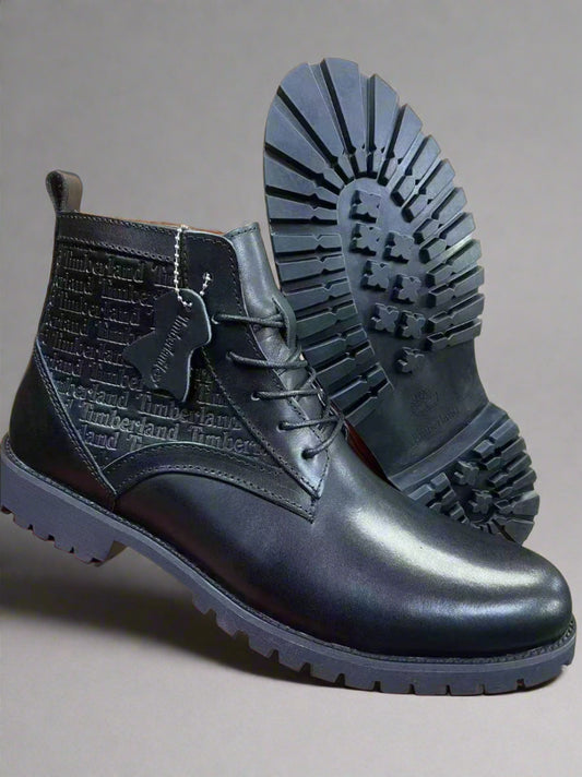 Black leather boots with a prominent sole on a red and black platform.