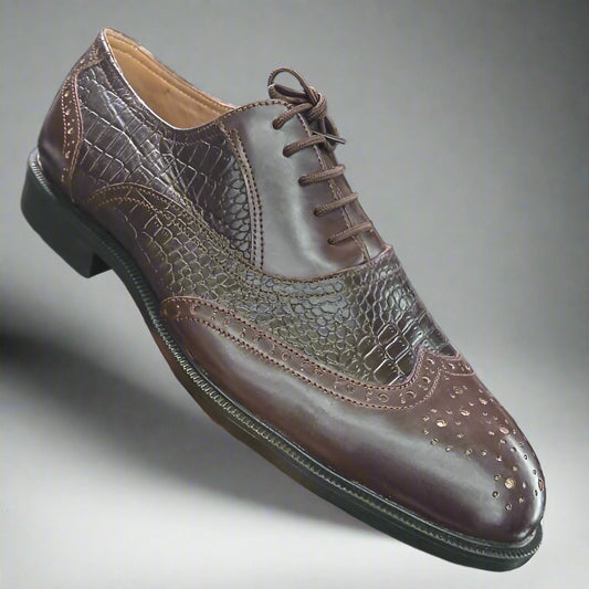 Brown leather shoe held in front of a shoe rack with various shoes displayed.