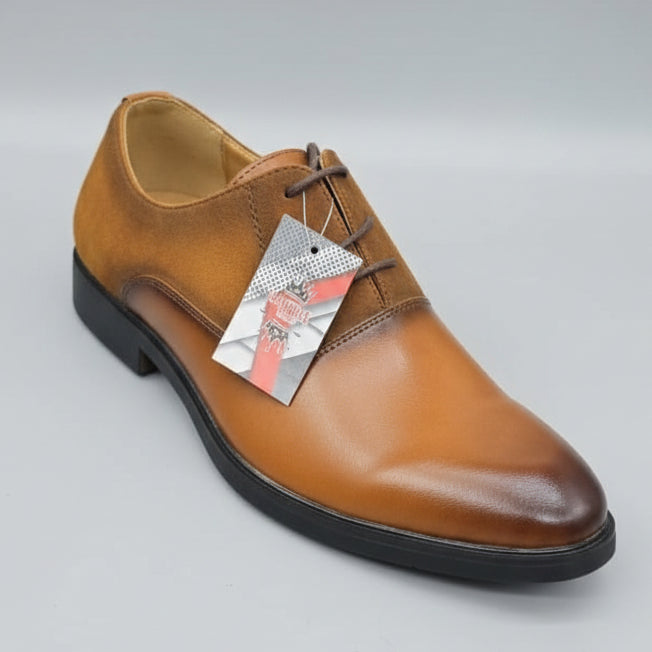 Brown leather shoe held by a hand with a blurred store background