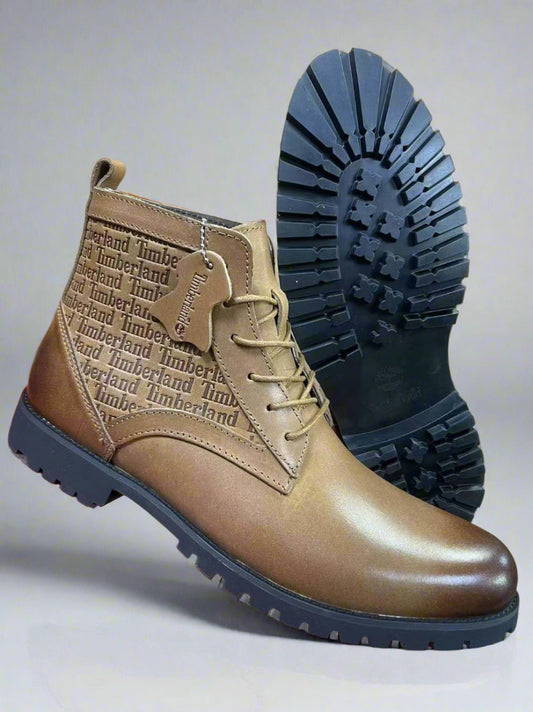 Brown leather boot with black sole on a red surface, brand name visible.