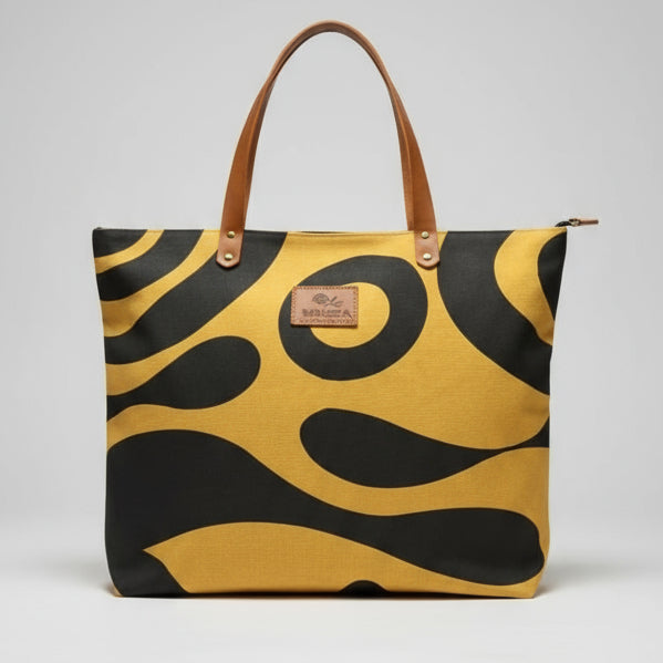 Person holding a yellow and black patterned bag indoors